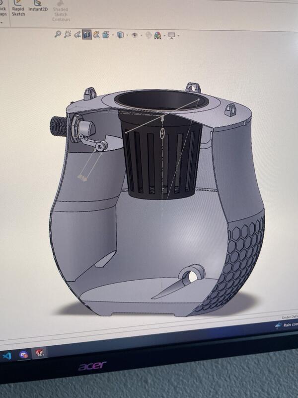 SolidWorks CAD cross-section showing internal reservoir, net cup, and float valve